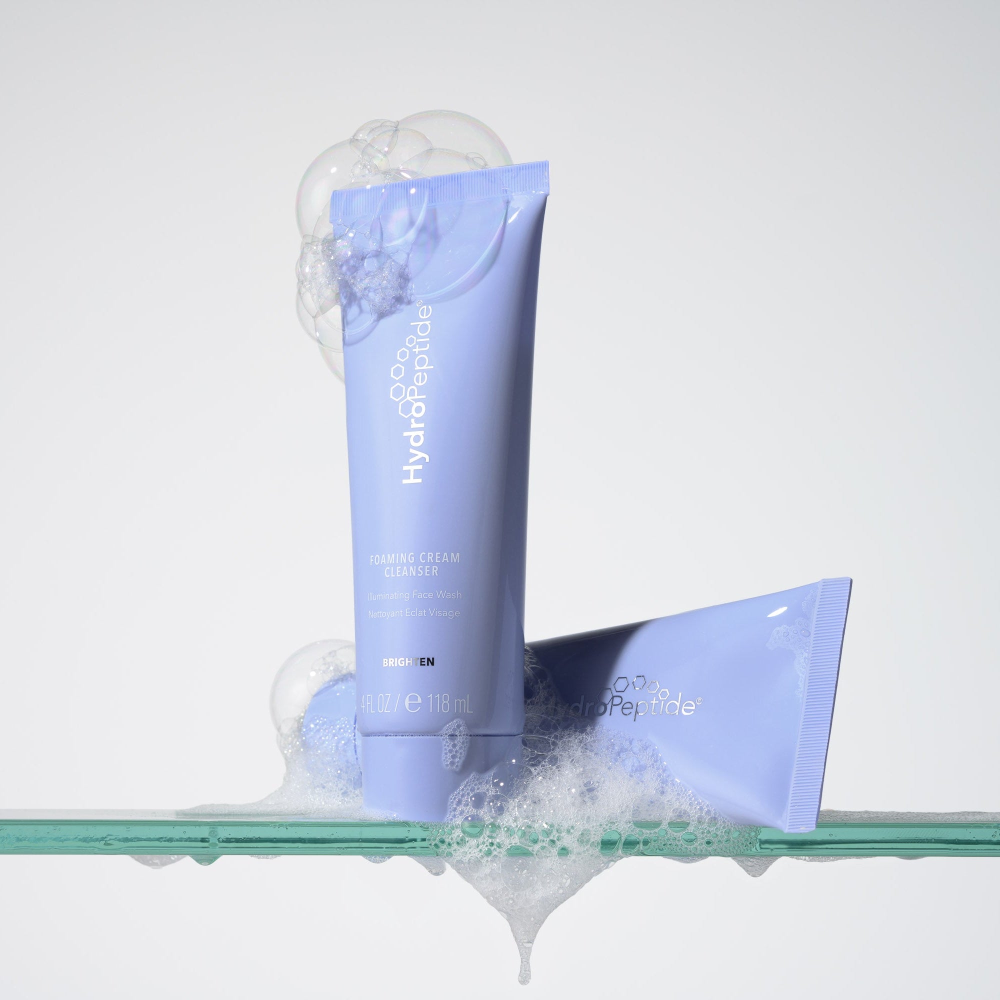 Blue skincare tube with white text on a clear background