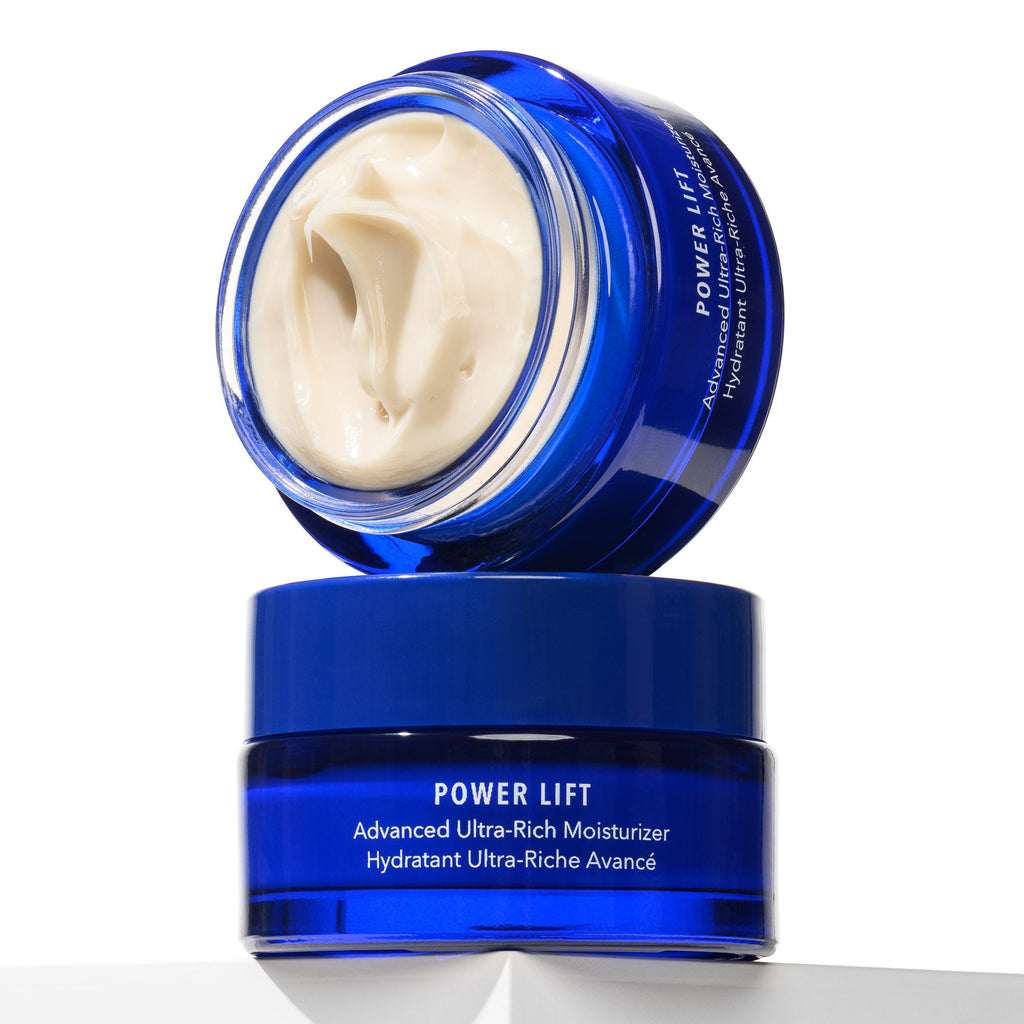 Blue skincare jar with white cream on a white background